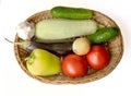 Zucchini, tomatoes, cucumbers, garlic, onions, bell peppers and eggplant are in a wicker basket Royalty Free Stock Photo